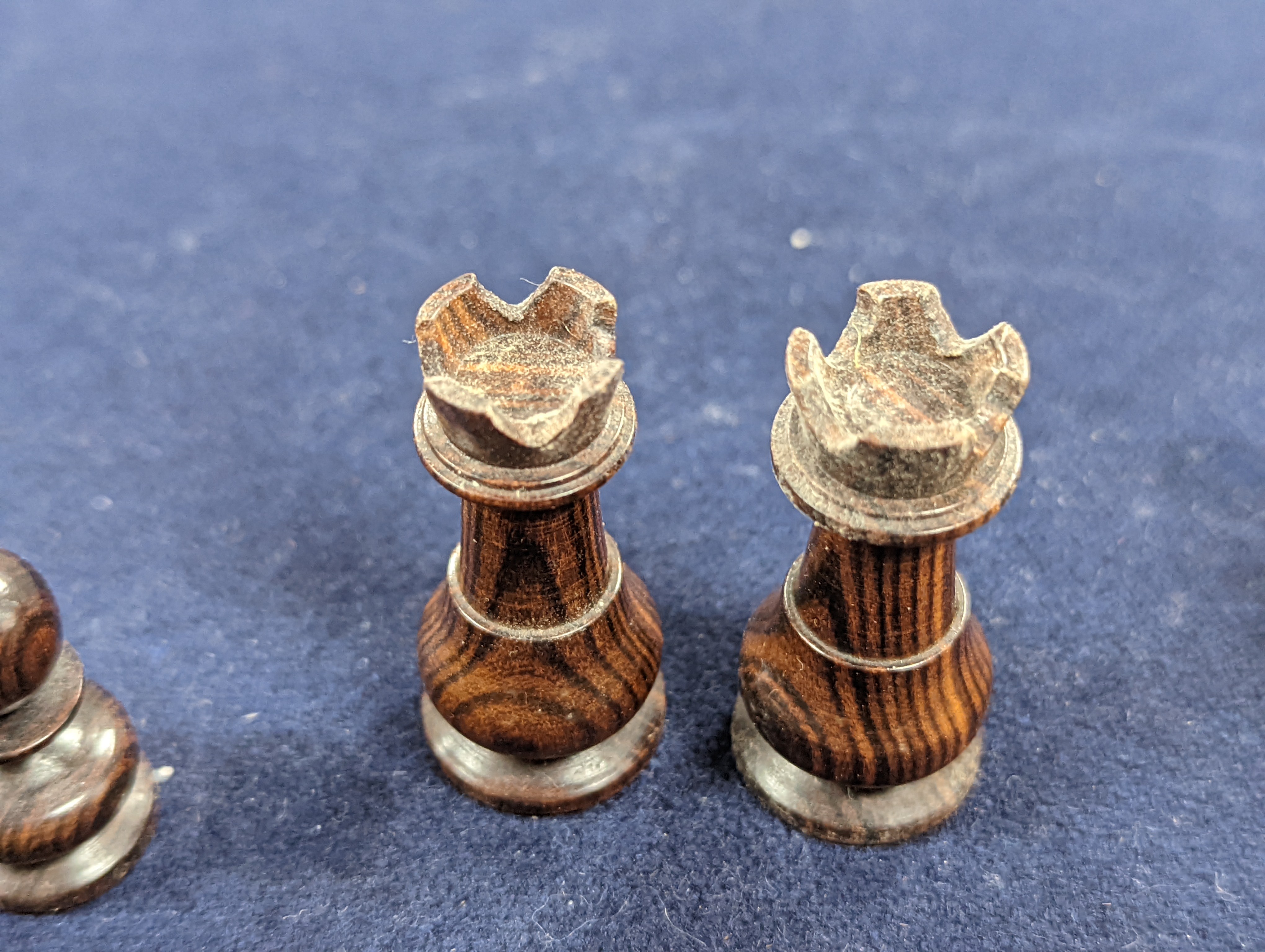 A Victorian brass inset mahogany games box, fitted with solitaire, cribbage, chessmen, draughts etc., 33cm, a turned and stained bone chess set, another games box containing chessmen and draughts